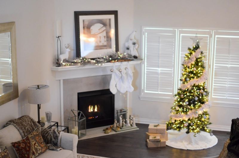 tree near fireplace in white room